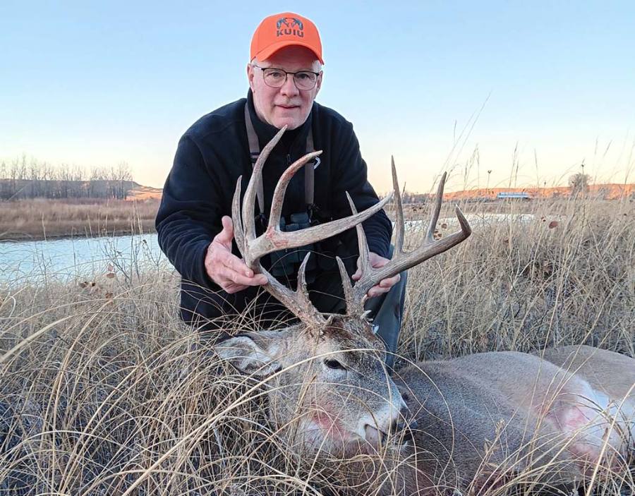 Hunter with a heavy-beamed South Dakota whitetail buck