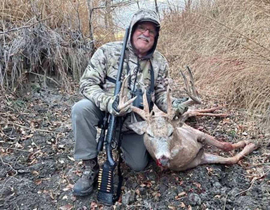 Hunter with a South Dakota whitetail buck taken in the river bottoms